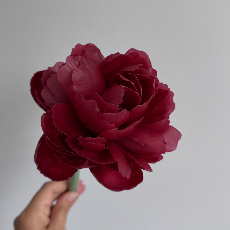 Realistic peony candle on a stem