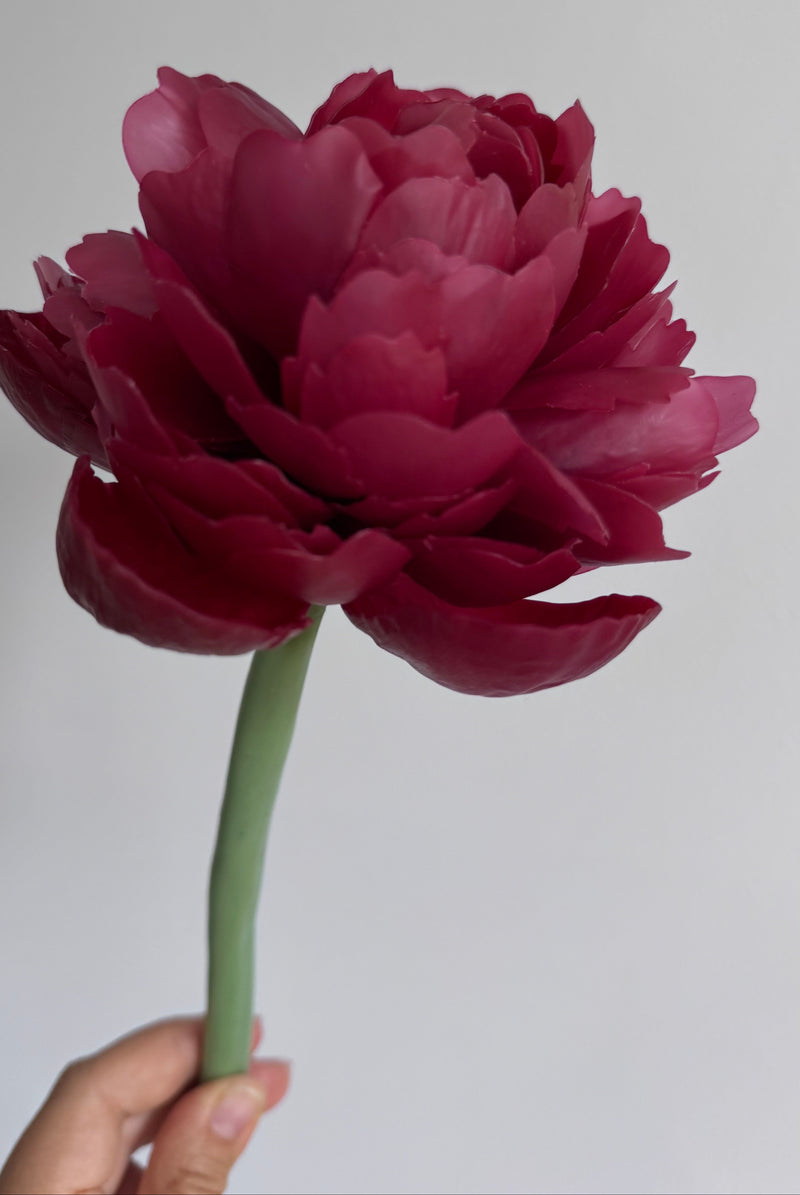 Realistic peony candle on a stem